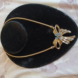 Vintage costume goldtone bow necklace with blue rhinestones.  Missing 1 stone.